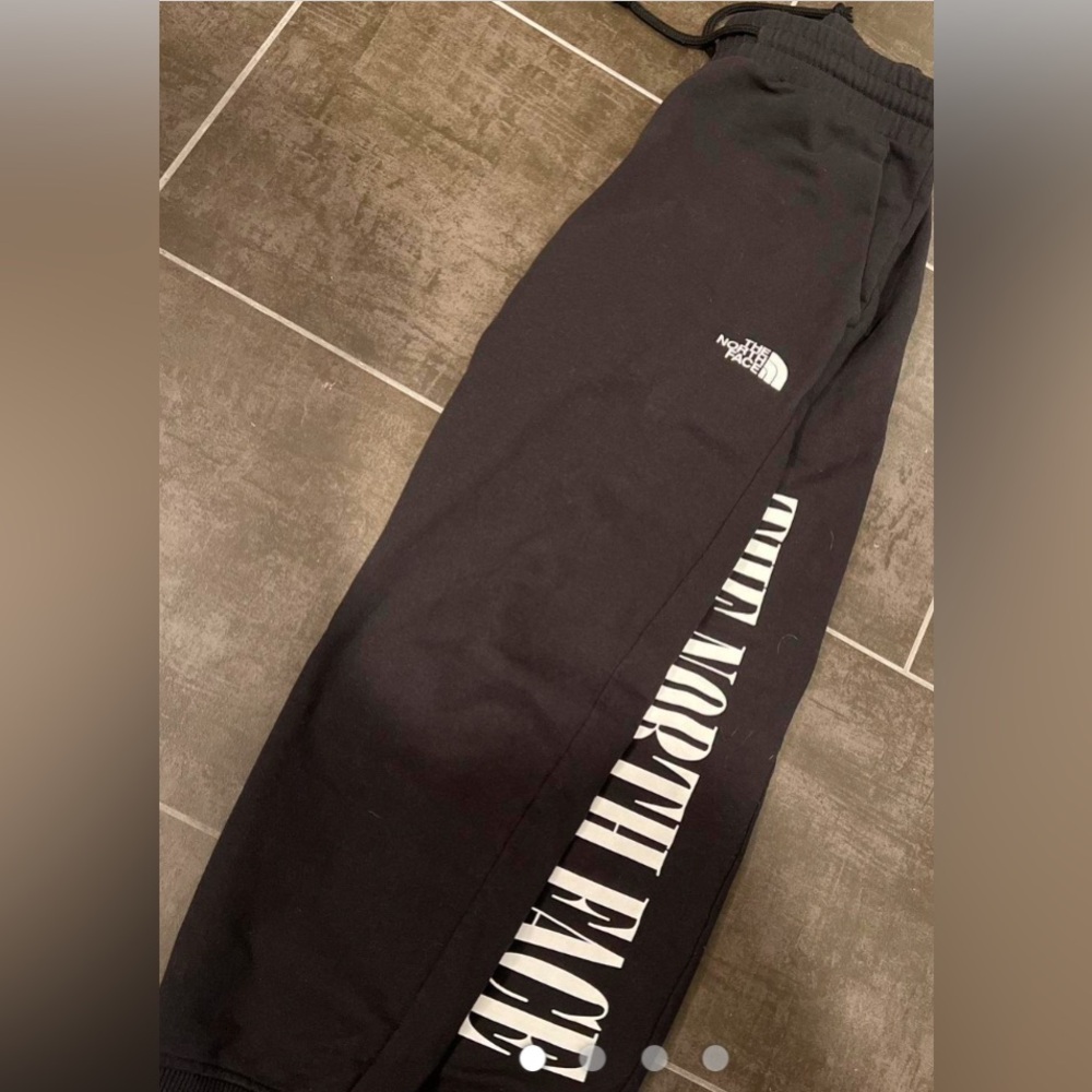 Small north face sweatpants with north face written up the leg
